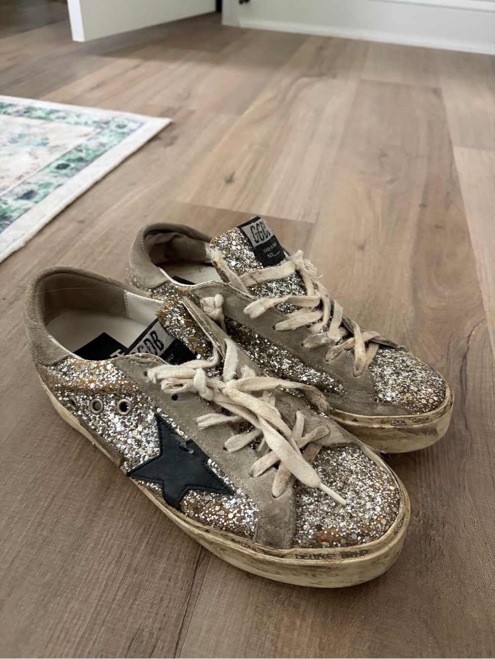 Golden Goose women’s Glitter Star Sneakers in Silver and Black